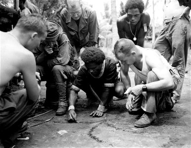 SC 166662 - Native Police boy draws a map on the ground showing the position of enemy forces.