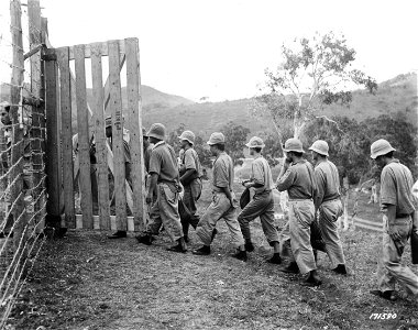 SC 171590 - First Island Command, New Caledonia. Jap prisoners enter new prison camp built for them while they were being temporarily housed in a warehouse. 7 January, 1945.