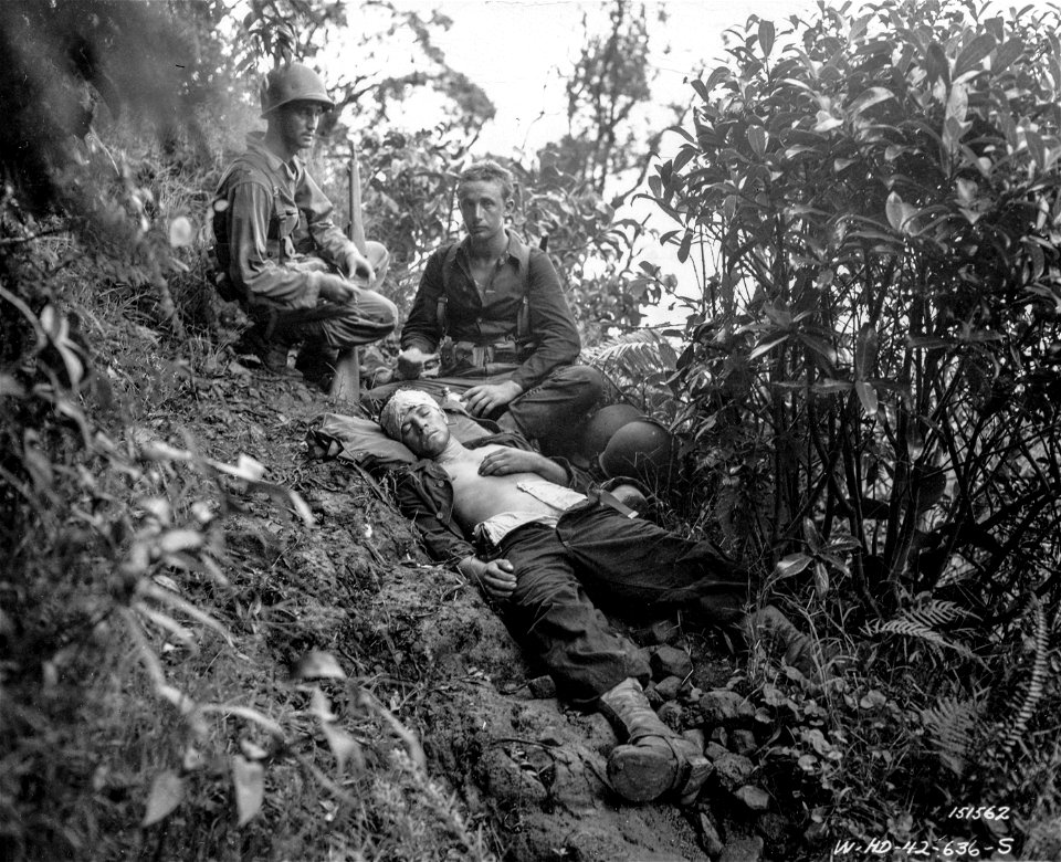 SC 151562 - Red Cross workers taking time out to give first aid to one of their wounded soldiers during maneuvers. Hawaii.