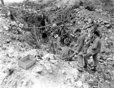 SC 270786 - Men of Co. "B", 184th Inf. Regt. looking over a captured Jap gun emplacement. 30 May, 1945.