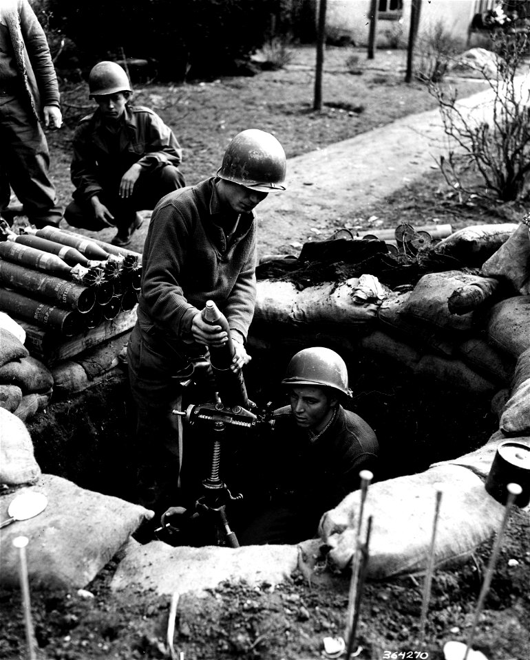 SC 364270 - Firing a mission with 81mm mortar are, L to R: Pvt. Ernest Dolloff, Hamilton, Texas, and Cpl. John F. Richards, Pompton Lakes, N.J.