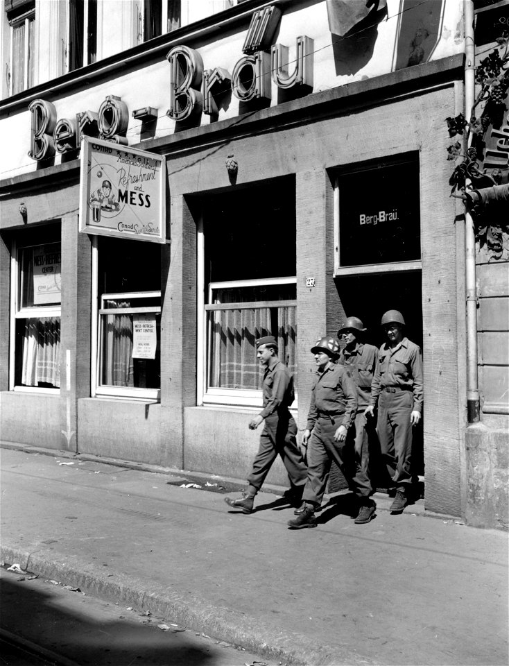 SC 335293 - Soldiers riding army convoys through old Heidelberg, picturesque German university town in the Neckar Valley, eat at this German restaurant which has been turned into a mess and refreshment center by CONAD Special Services. 11 May, 1945.