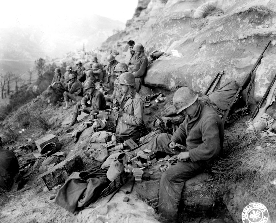 SC 396833 - Infantrymen of Co. "B" of the 361st Inf., of the 91st Division, eating the new type "K" rations, which they say are better than the old type.