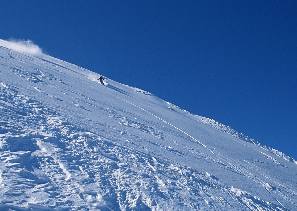 Skier coming down the slope fast