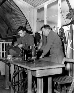 SC 405008 - Russian tailors use German equipment in a camp for liberated Russians at Rennes, France, to make all their own clothes with the exception of U.S. Army fatigues which the Army gives them.
