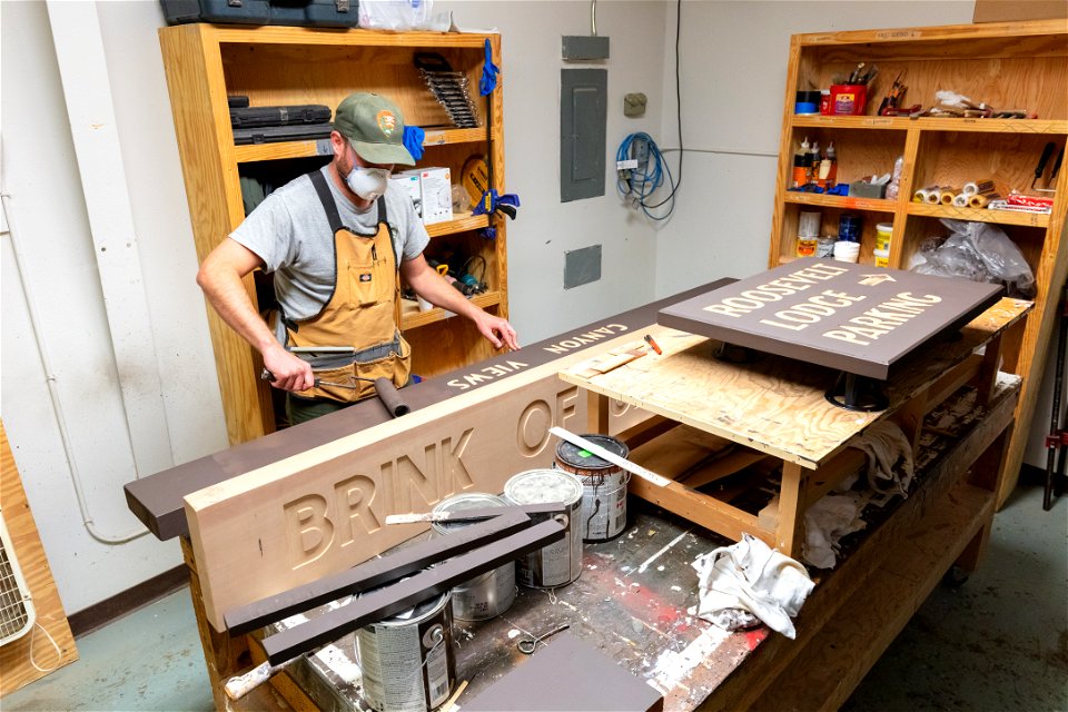 Painting a sign in the sign shop