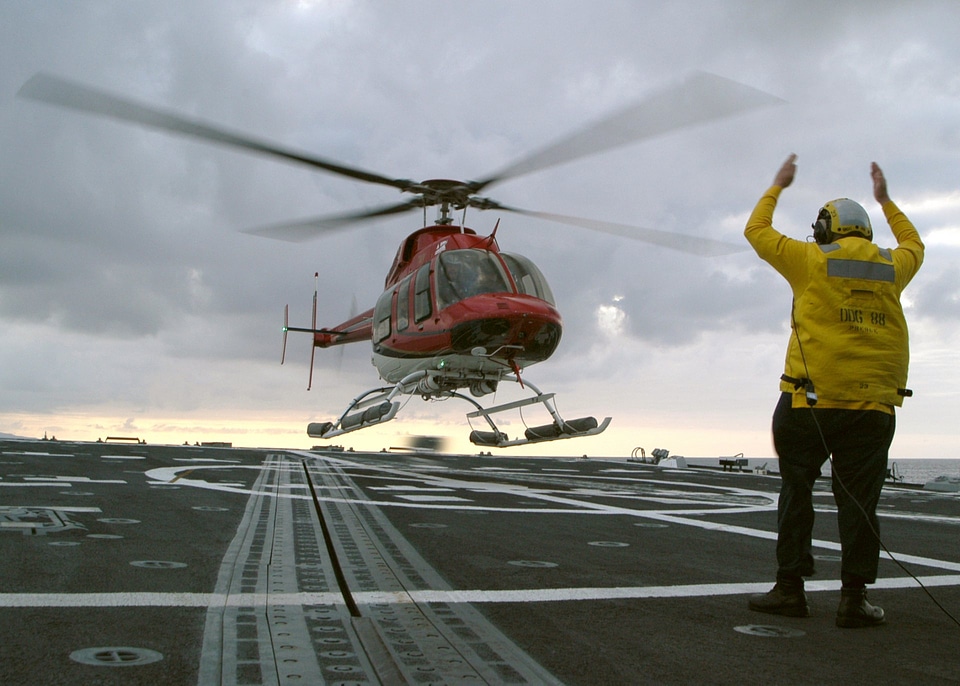 Class Tito Alvarez directs a commercial Bell 4 helicopter