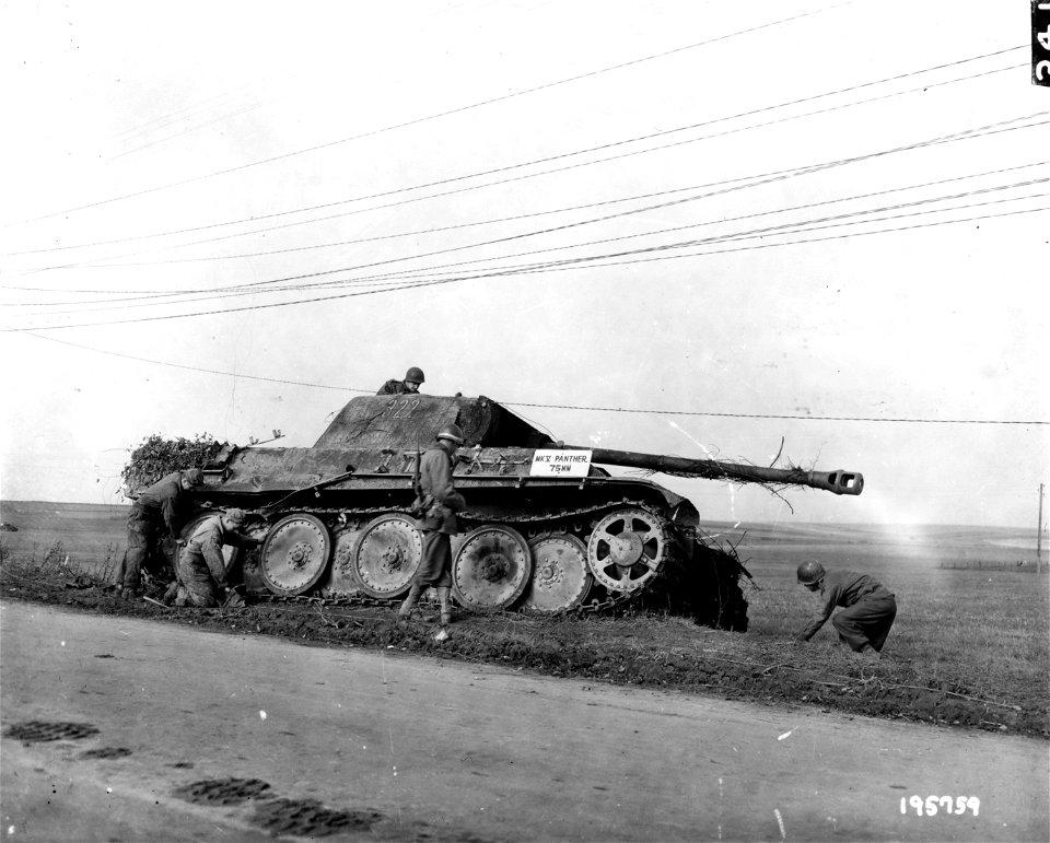 SC 195759 - American soldiers of the 5th Division give this German tank a close scrutiny. 29 October, 1944.