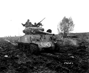SC 196105-S - This M-4 medium tank is put thru the (?) in the mud by members of the Motor transport unit, near Nancy, France. 5 November, 1944. photo