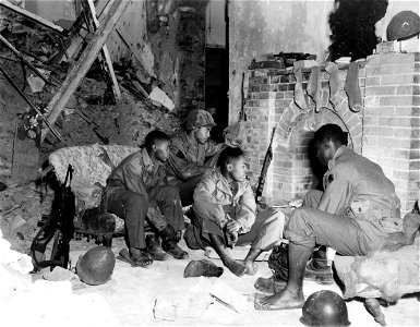 SC 364370 - In a bomb shattered house members of the 92nd Inf. Div. are drying out. 14 December, 1944. photo