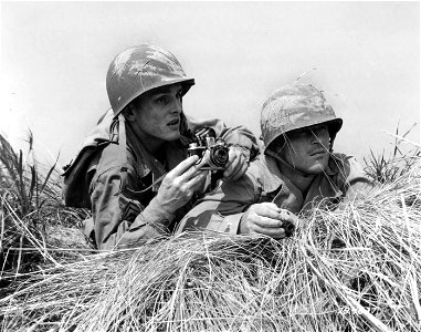 SC 184877 - Pictured are T/5 Leo M. Churan and Pfc. Lawrence J. Supp, both of the Signal Section 1855th Unit for the purpose of showing how photographers work under combat conditions. 1943. photo