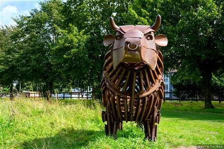 On the way out of town on Old Walton Road There's a twenty foot rusty bull With a ring right through it's nose. photo