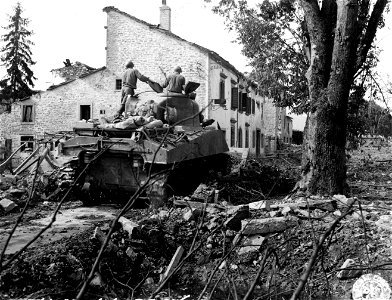 SC 195713 - Tank-dozer of 752nd Tank Bn. clears debris from road in Firenzuola, Italy. 23 September, 1944. photo