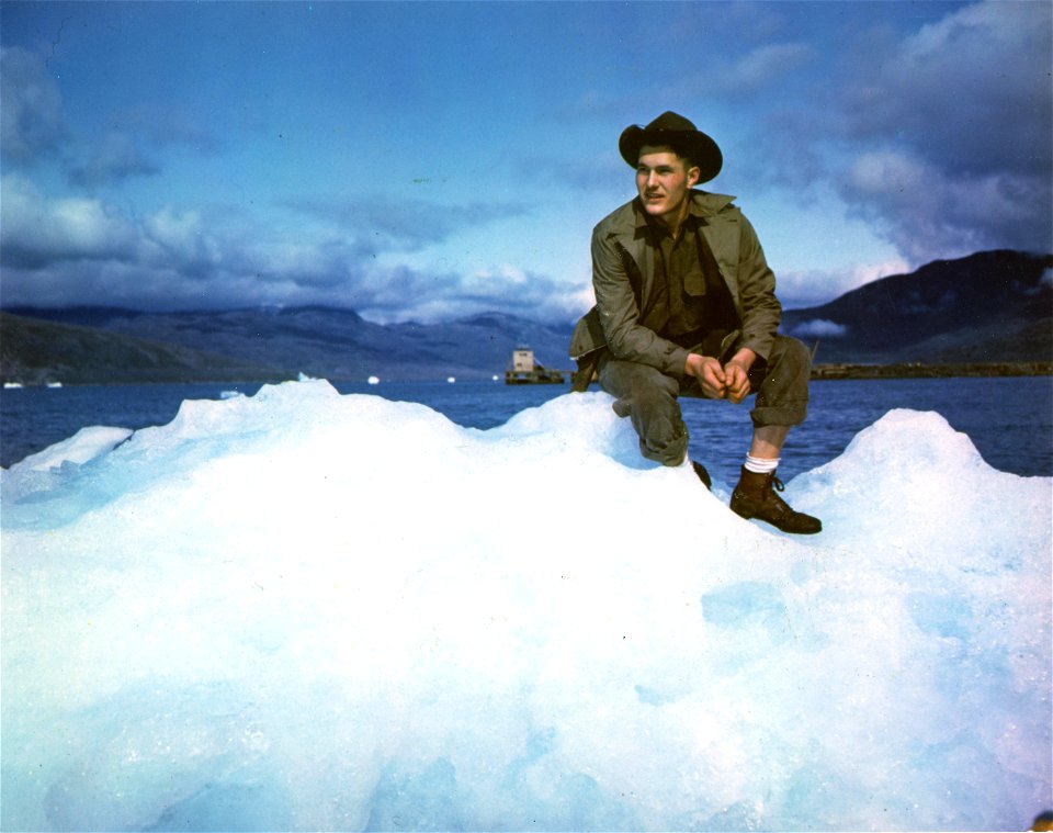 C-874 - GI sitting on a small glacier, facing the camera. Greenland.