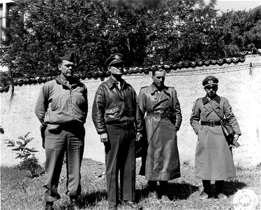 SC 337131 - L-R: Col. William S. Ladue of C of S, IV Corps; Maj. Gen. Willis D. Crittenberger, C.G., IV Corps; Maj. Gen. Max Joseph Pemsel, C of S, Ligurian Army (German), and Maj. Kneip, aide to Gen. Pemsel... photo