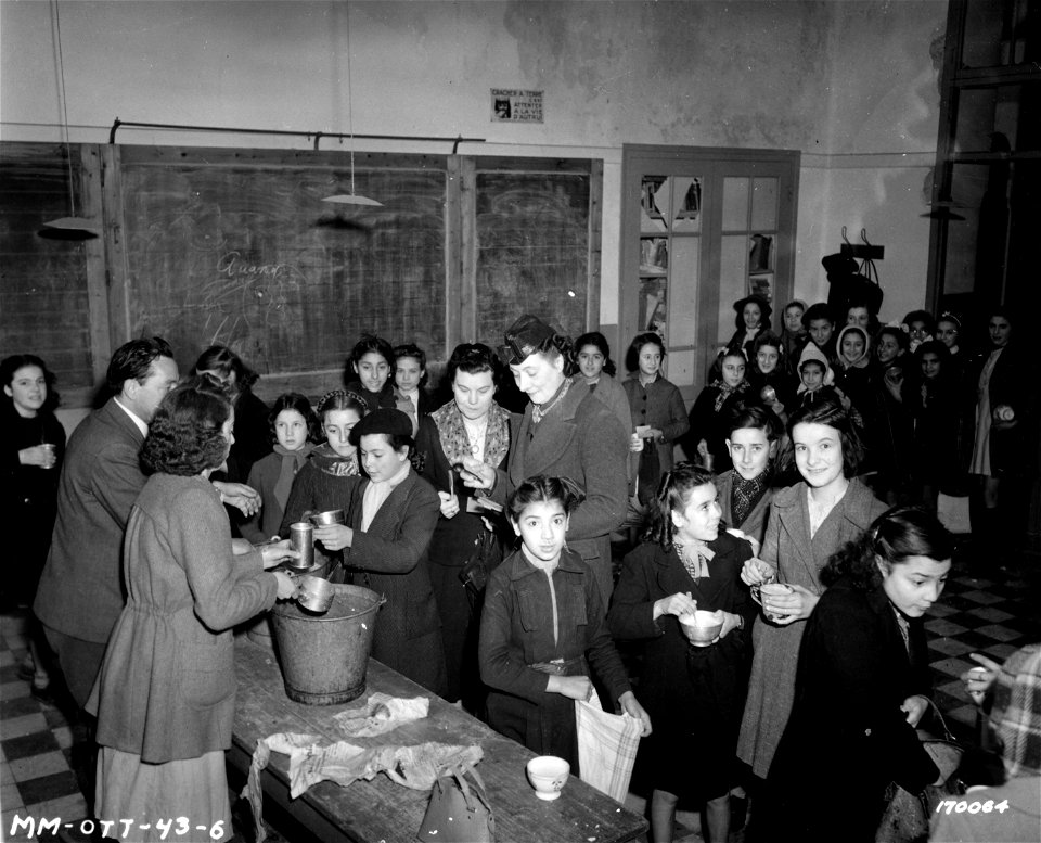 SC 170064 - French children receiving their daily ration of 3/4 pint of milk at a bombed school in N. Africa.