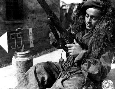 SC 374839 - L/Cpl. Jacob Feinbuch, once of Essen, Germany, and now from Palestine, prepares his sniper rifle for action. 24 March, 1945. photo
