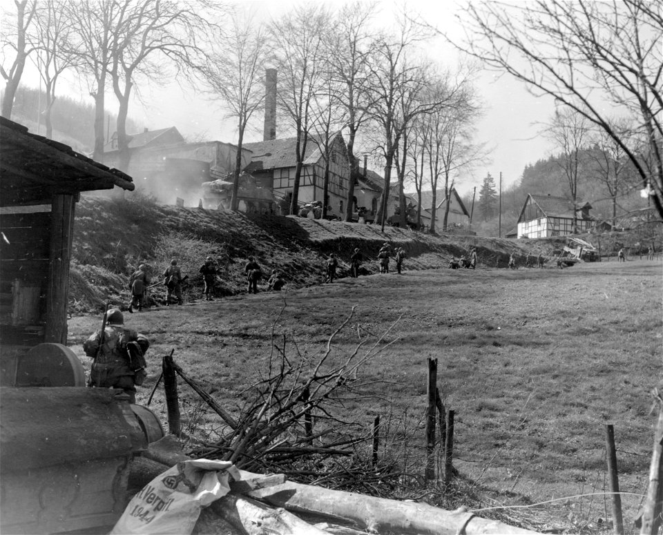 SC 270691 - Infantrymen of the 5th Division, 3rd U.S. Army, skirt the newly-taken town of Grevenstein, Germany, to attack a nearby hill which the Germans are using for an observation post. 11 April, 1945.