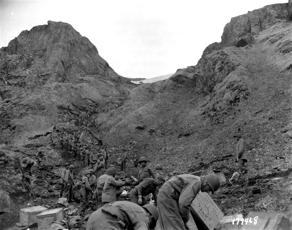 SC 179468 - While the American forces were fighting the Japanese in the Chichagof area, supplies were brought to them by means of hand to hand carry, by lines of men extended over the route over which the supplies had to be moved...