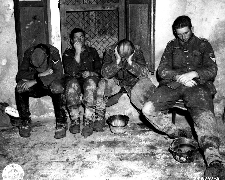 SC 196141-S - The "Master Race" finds many unmasterly poses these days. These German soldiers have arrived at a Prisoner of War camp.
