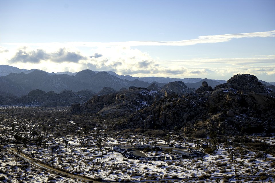 Snow over the Barker Dam parking area near sunset