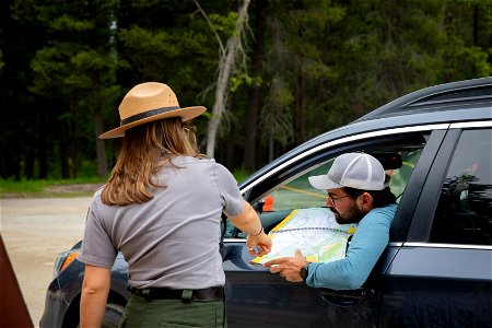 Ranger assists a visitor with questions about vehicle reservations photo