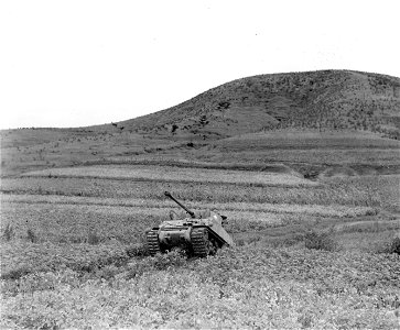 SC 348652 - U.S. M-4 tank of the 23rd Inf. Regt., 2nd Inf. Div., advances up gully to support inf. troops during advance against North Korean enemy force near Yongsan. 16 September, 1950.