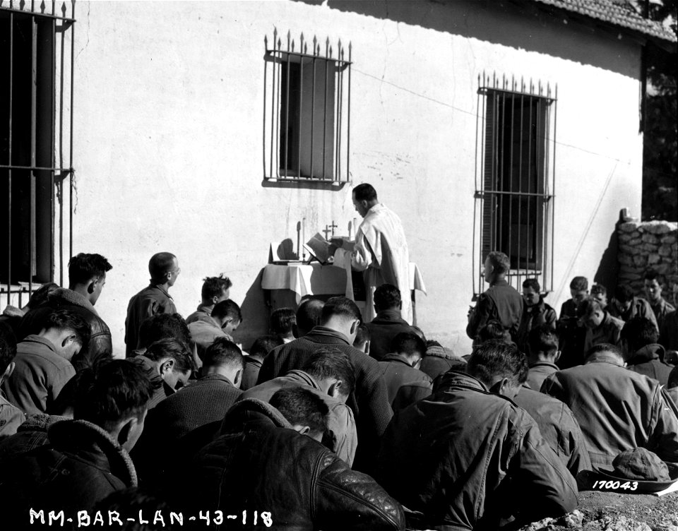 SC 170043 - Chaplain Walter J. Poynton, Inglewood, N.J, holds church services in the courtyard of a French school building for a bomber group in North Africa. 12 February, 1943. photo