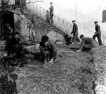 SC 374759 - Two members of Co. "C", 1st Bn., 337th Regt., roll their bed rolls in preparation to leave their C.P. for a new area.