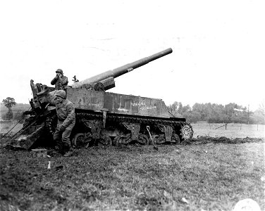SC 196159 - Returning captured Nazi ammunition, this 155mm gun crew are firing their piece towards the German lines. photo