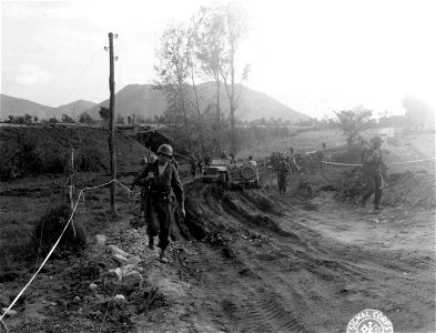 SC 270612 - Co. D, 30th Inf., 3rd Inf. Div. bypassing a bridge blown up by retreating Germans. photo