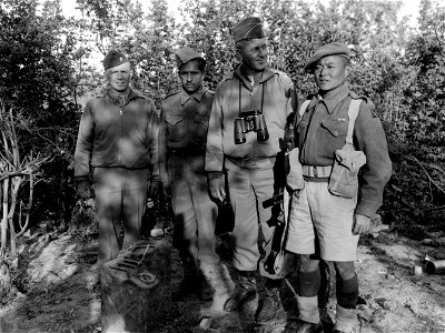 SC 329929 - L-R: Lt. Col. Earl Hormell, aide to Gen. Devers, and Lt. Gen. Jacob L. Devers, Deputy Supreme Commander, Me. Theater, pose with Ghurka troops as the general visits the front that the Ghurka is fighting on. Orsogna Sector, Italy. photo