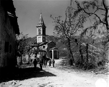 SC 329857 - U.S. Army communications troops walk past the shell-torn church in Salvaro, Italy.