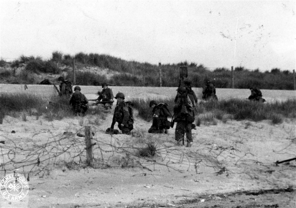 SC 270657 - Land flooded by Hitler's forces in an effort to "bog down" the invasion forces proves little detriment to the American assault troops.