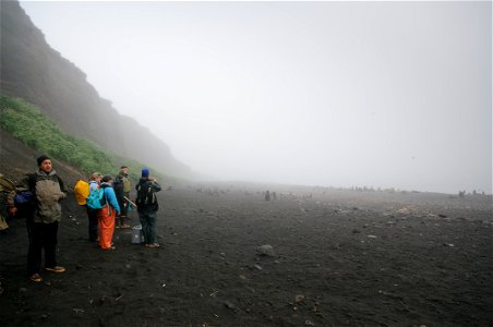 Puffin researchers on Bogoslof Island, foggy beach photo