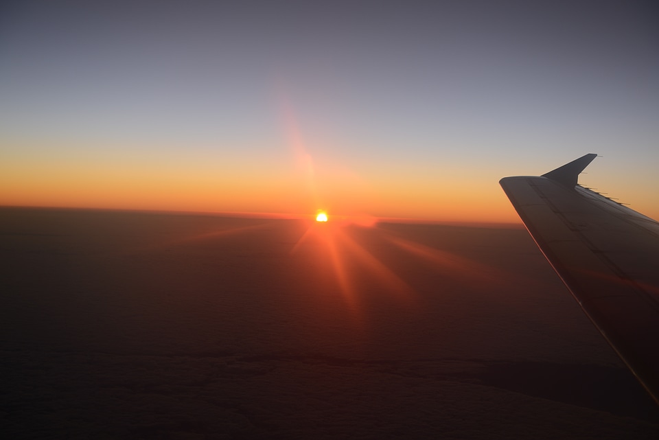 Wing of an airplane in the sunset
