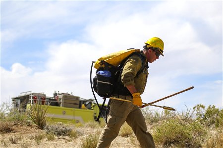 MAY 15: Firefighter with backpack fire pump and tools photo