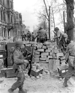 SC 270698 - After crossing main river, infantrymen of the 5th Division, Third U.S. Army, advance into Frankfurt, Germany, in pursuit of fleeing Nazis. 21 March, 1945. photo