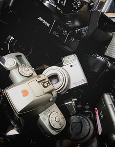 An assortment of used, dusty, disposable cameras