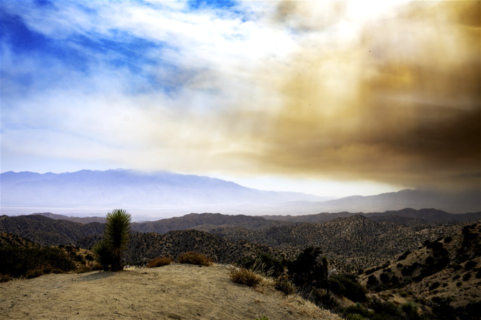 Smoke from the Apple Fire over desert hills and San Jacinto