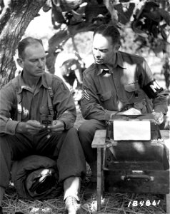 SC 184861 - Provost Marshal Major Thomas Lanser, New York, and Sgt. [illegible] H. Cummingham, Hartford, Conn., at work in their "office" in 1st Division C.P. in a cactus grove, near Barrafranca, Sicily.