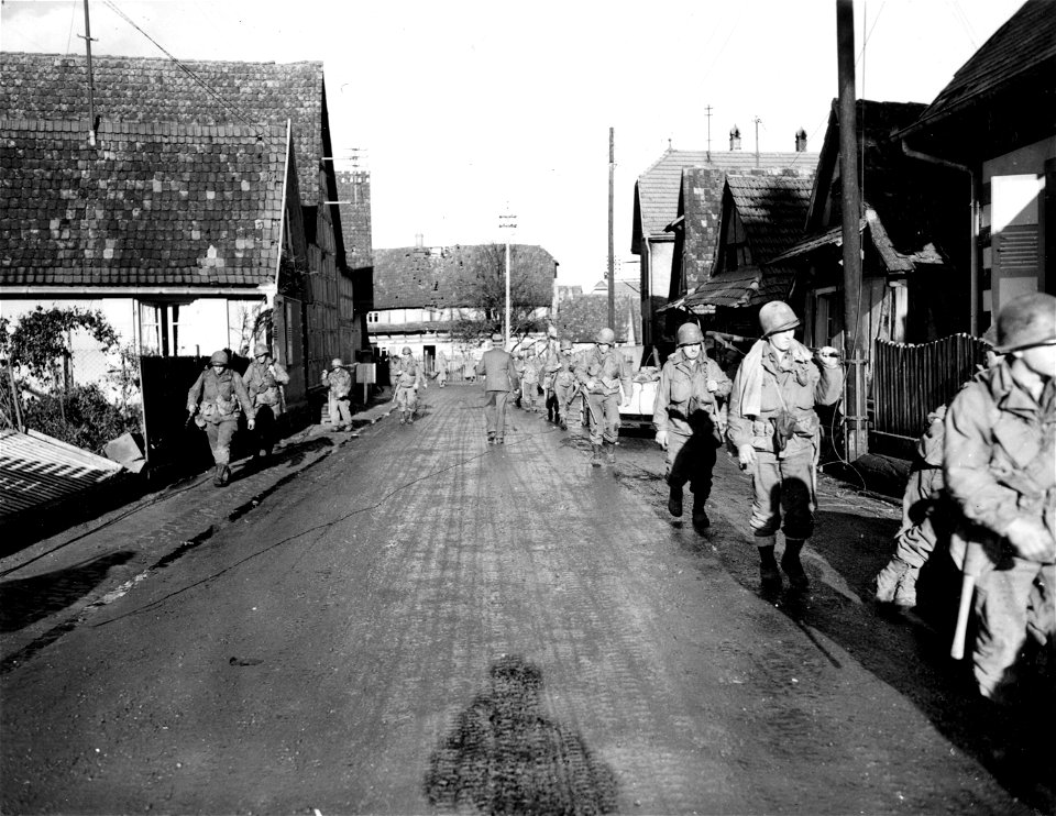 SC 270822 - Infantrymen of the 79th Division file into columns down street of newly-captured town of Soufflenheim, France.