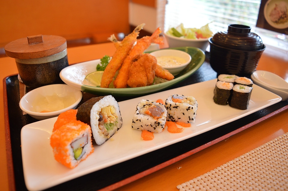 Sushi set, TEPURA and sakura branch on bamboo mat