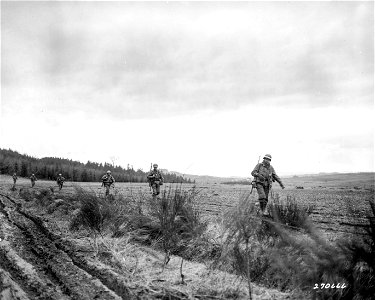 SC 270666 - U.S. troops of Company K, 22nd Infantry Regiment, 4th Division, U.S. Third Army, who have just finished an engagement with the enemy, move up to new positions in order to outflank the Germans... photo