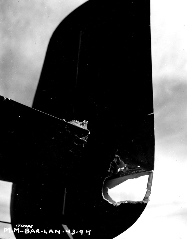 SC 170048 - The damaged tail of a B-25 bomber caused by enemy ack-ack fire. Berteaux, North Africa. 11 February, 1943.