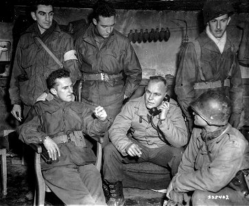 SC 335402 - Battalion staff awaits return of a twenty-five man patrol from across the Roer River.