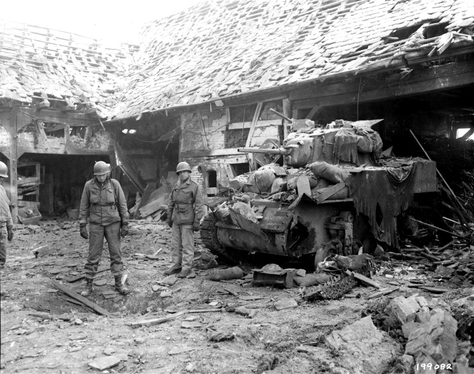 SC 199082 - A bomb dropped by a German plane set off five boxes of land mines, destroying surrounding houses and damaging this M-5A1 light tank.