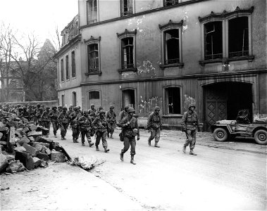 SC 270631 - Infantrymen of the U.S. 7th Army move out of Zweibrucken, Germany, to take position on ridge above the town. 20 March, 1945. photo