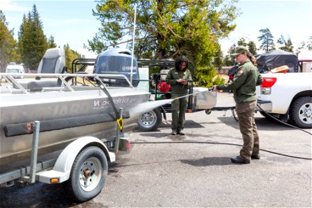 AIS technicians decontaminating a motorized boat and trailer photo