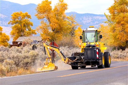 Mowing operations along road shoulders in Mammoth Hot Springs